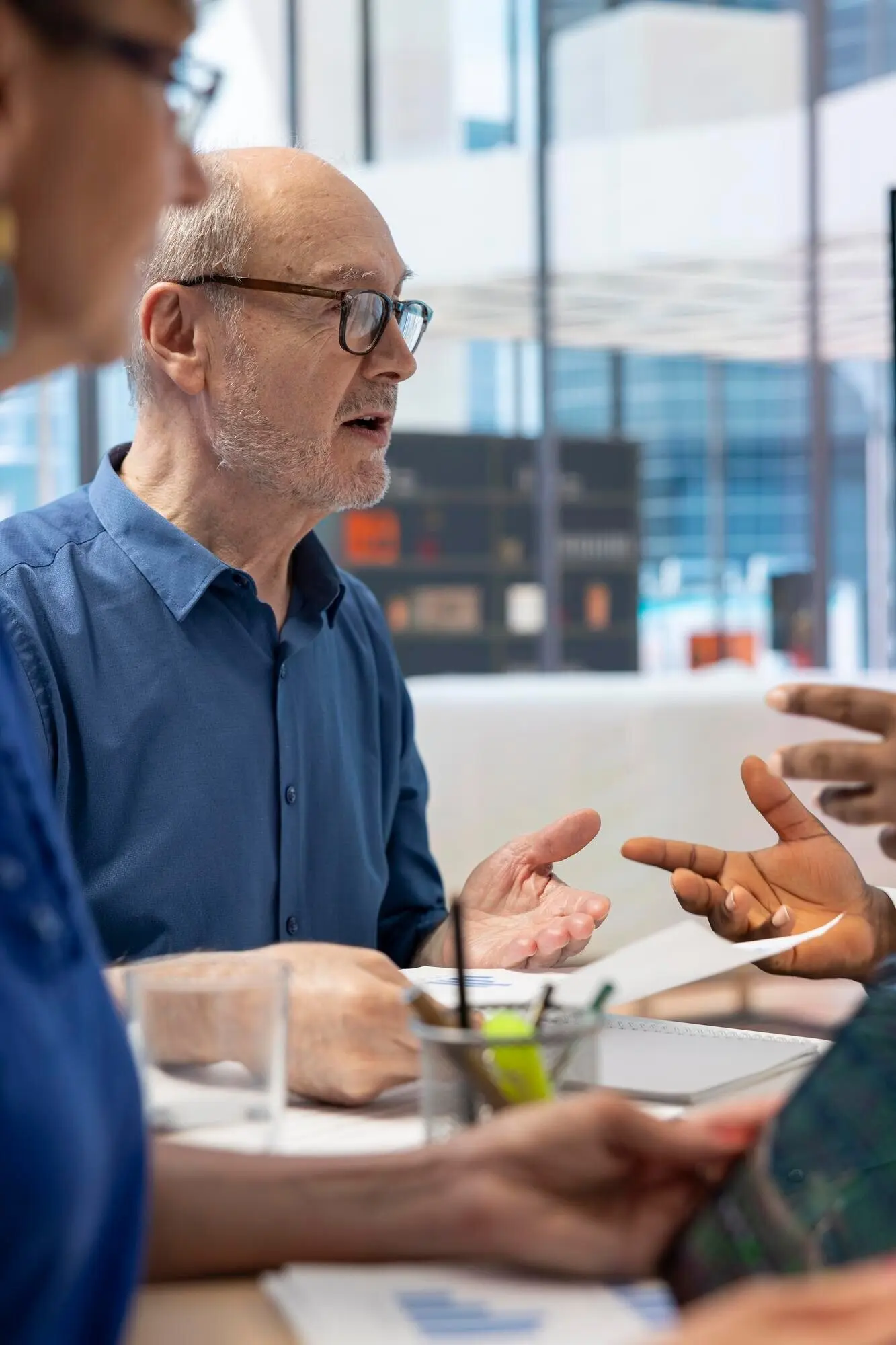 Pareja madura reunida con un experto financiero para elaborar un plan de jubilación detallado.